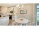 Cozy breakfast nook with white table, pendant lighting, and white cabinets at 491 Daylily Blvd, Nokomis, FL 34275