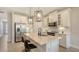 Bright kitchen features white cabinets, pendant lighting and a large island with barstool seating at 491 Daylily Blvd, Nokomis, FL 34275