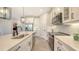 Beautiful kitchen features white cabinetry, stainless appliances, and a stylish island at 491 Daylily Blvd, Nokomis, FL 34275