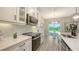 Well-appointed kitchen featuring quartz countertops, white cabinets and stainless steel appliances at 491 Daylily Blvd, Nokomis, FL 34275