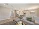 Open-concept living space with modern gray sofa, kitchen island, and adjacent dining area at 491 Daylily Blvd, Nokomis, FL 34275