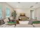 Bright living room featuring modern furnishings, a large window and decorative plant at 491 Daylily Blvd, Nokomis, FL 34275