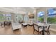 Community lounge area featuring comfortable seating, large windows, and a modern chandelier at 491 Daylily Blvd, Nokomis, FL 34275
