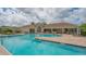 Community pool featuring clear blue water, ample seating, and clubhouse views at 491 Daylily Blvd, Nokomis, FL 34275