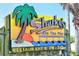 Vibrant Sharky's On The Pier sign, inviting visitors to a lively restaurant & tiki bar experience at 491 Daylily Blvd, Nokomis, FL 34275