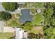 Aerial view of a well-maintained house with a lush backyard and green surroundings at 5415 13Th Avenue W Dr, Bradenton, FL 34209