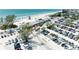 Aerial shot captures a beachside parking lot, sandy beach and clear ocean waters for recreation at 5415 13Th Avenue W Dr, Bradenton, FL 34209