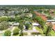 Aerial view of a home nestled in a serene neighborhood with mature trees and lush landscaping at 5415 13Th Avenue W Dr, Bradenton, FL 34209