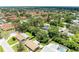 Aerial view of a home surrounded by mature trees in a quiet residential neighborhood at 5415 13Th Avenue W Dr, Bradenton, FL 34209