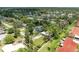 High aerial view of a home in a quiet neighborhood with green lawns and mature shade trees at 5415 13Th Avenue W Dr, Bradenton, FL 34209