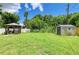 Backyard features a large grass area, a gazebo, and a shed with a blue sky overhead at 5415 13Th Avenue W Dr, Bradenton, FL 34209