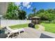 Backyard features a deck, a seating area, a barbecue grill, a gazebo, and a white fence at 5415 13Th Avenue W Dr, Bradenton, FL 34209