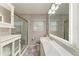 Bathroom features a glass enclosed shower and a vanity with a marble countertop and sink at 5415 13Th Avenue W Dr, Bradenton, FL 34209