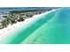 Panoramic aerial view of a stunning white sand beach with clear turquoise ocean waters at 5415 13Th Avenue W Dr, Bradenton, FL 34209