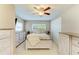 Cozy bedroom featuring a ceiling fan, natural light, and a calm, neutral color scheme at 5415 13Th Avenue W Dr, Bradenton, FL 34209