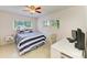 Bright bedroom featuring a blue and white color scheme, a study desk, and ample natural light at 5415 13Th Avenue W Dr, Bradenton, FL 34209