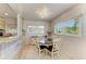 Charming dining area with a round table, four chairs, and a bright window with garden views at 5415 13Th Avenue W Dr, Bradenton, FL 34209