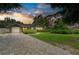 Lovely home with a brick driveway and beautiful landscaping under a colorful sunset sky at 5415 13Th Avenue W Dr, Bradenton, FL 34209