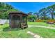 Well-maintained gazebo with seating surrounded by a lush green lawn and mature trees at 5415 13Th Avenue W Dr, Bradenton, FL 34209
