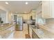 Spacious kitchen features granite countertops, tiled backsplash, and stainless steel refrigerator at 5415 13Th Avenue W Dr, Bradenton, FL 34209