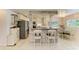 Stylish kitchen with white cabinets, modern appliances, and adjacent dining area at 5415 13Th Avenue W Dr, Bradenton, FL 34209