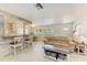 Open living area featuring a breakfast bar, natural lighting, and tile flooring at 5415 13Th Avenue W Dr, Bradenton, FL 34209
