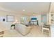Bright living room with tile flooring, neutral decor, and comfortable seating area with views of the yard at 5415 13Th Avenue W Dr, Bradenton, FL 34209