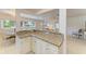 Cozy breakfast bar with granite countertops that opens into the bright and airy living room at 5415 13Th Avenue W Dr, Bradenton, FL 34209