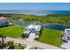 Expansive aerial view of the property showcasing lush landscaping, waterfront access, and a serene setting at 5630 Inspiration Ter, Bradenton, FL 34210