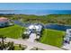 Expansive aerial view of luxury home with stunning curb appeal, lush landscaping and waterfront access at 5630 Inspiration Ter, Bradenton, FL 34210
