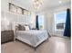 Bright bedroom featuring hardwood floors, stylish furniture, and large windows at 5630 Inspiration Ter, Bradenton, FL 34210