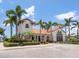Attractive community building surrounded by palm trees and colorful landscaping at 5630 Inspiration Ter, Bradenton, FL 34210