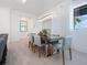 Elegant dining area featuring modern light fixture, comfortable seating, and serene decor at 5630 Inspiration Ter, Bradenton, FL 34210