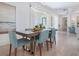 Elegant dining area featuring modern light fixture, comfortable seating, and serene decor at 5630 Inspiration Ter, Bradenton, FL 34210