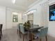 Dining room featuring an elegant chandelier over a glass table and seating for six at 5630 Inspiration Ter, Bradenton, FL 34210