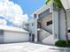 Modern home entrance with sleek metal railings, double front doors, and contemporary design at 5630 Inspiration Ter, Bradenton, FL 34210
