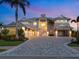 Elegant home with a driveway and well-maintained landscaping at twilight at 5630 Inspiration Ter, Bradenton, FL 34210