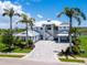 Beautiful home featuring well-manicured landscaping, palm trees, and an elegant facade at 5630 Inspiration Ter, Bradenton, FL 34210