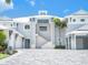 Elegant home featuring a neutral paint scheme, striking staircase, and well-lit facade at 5630 Inspiration Ter, Bradenton, FL 34210