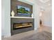Living room fireplace with a stone facade and a modern, linear design and flat screen TV at 5630 Inspiration Ter, Bradenton, FL 34210