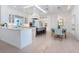 Bright, spacious kitchen with marble countertops, white cabinetry, and modern appliances and dining area at 5630 Inspiration Ter, Bradenton, FL 34210