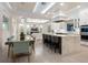 Modern kitchen with a large island, bar seating, and a dining area with a decorative chandelier at 5630 Inspiration Ter, Bradenton, FL 34210