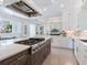 Gourmet kitchen boasts a large island, premium appliances, custom cabinetry, and seamless transition to the living area at 5630 Inspiration Ter, Bradenton, FL 34210