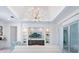 Stylish living room with custom built-ins, a modern chandelier, and seamless indoor-outdoor flow at 5630 Inspiration Ter, Bradenton, FL 34210