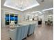 Open-concept living room featuring modern lighting, light wood floors and open access to the gourmet kitchen at 5630 Inspiration Ter, Bradenton, FL 34210
