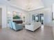 Airy living room featuring stylish seating, a modern entertainment center, and ample natural light at 5630 Inspiration Ter, Bradenton, FL 34210