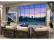 An outdoor patio offers a comfortable space with views of the pool and surrounding landscape at 5630 Inspiration Ter, Bradenton, FL 34210