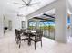 Spacious patio featuring an outdoor dining area with views of the lake and surrounding landscape at 5630 Inspiration Ter, Bradenton, FL 34210