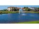 Scenic pond with fountain surrounded by lush landscaping and homes in the background at 5630 Inspiration Ter, Bradenton, FL 34210