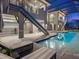 Gorgeous interior pool view featuring a contemporary design with stairs and lounge chairs at 5630 Inspiration Ter, Bradenton, FL 34210